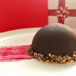Chocolate dome, praline mousse and raspberry melting heart: The image is a representative of the step 22