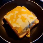 Grilled cheese with eggs and marbled cheddar: The image is a representative of the step 4
