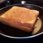 Grilled cheese with eggs and marbled cheddar: The image is a representative of the step 6