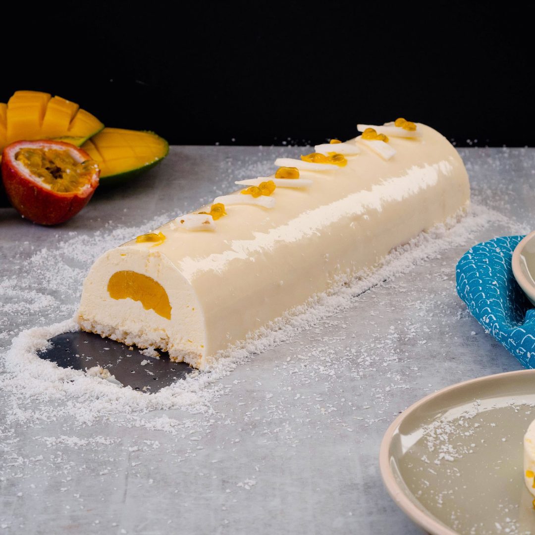 The photo represents the recipe: Mango, Passion Fruit, and Coconut Yule Log