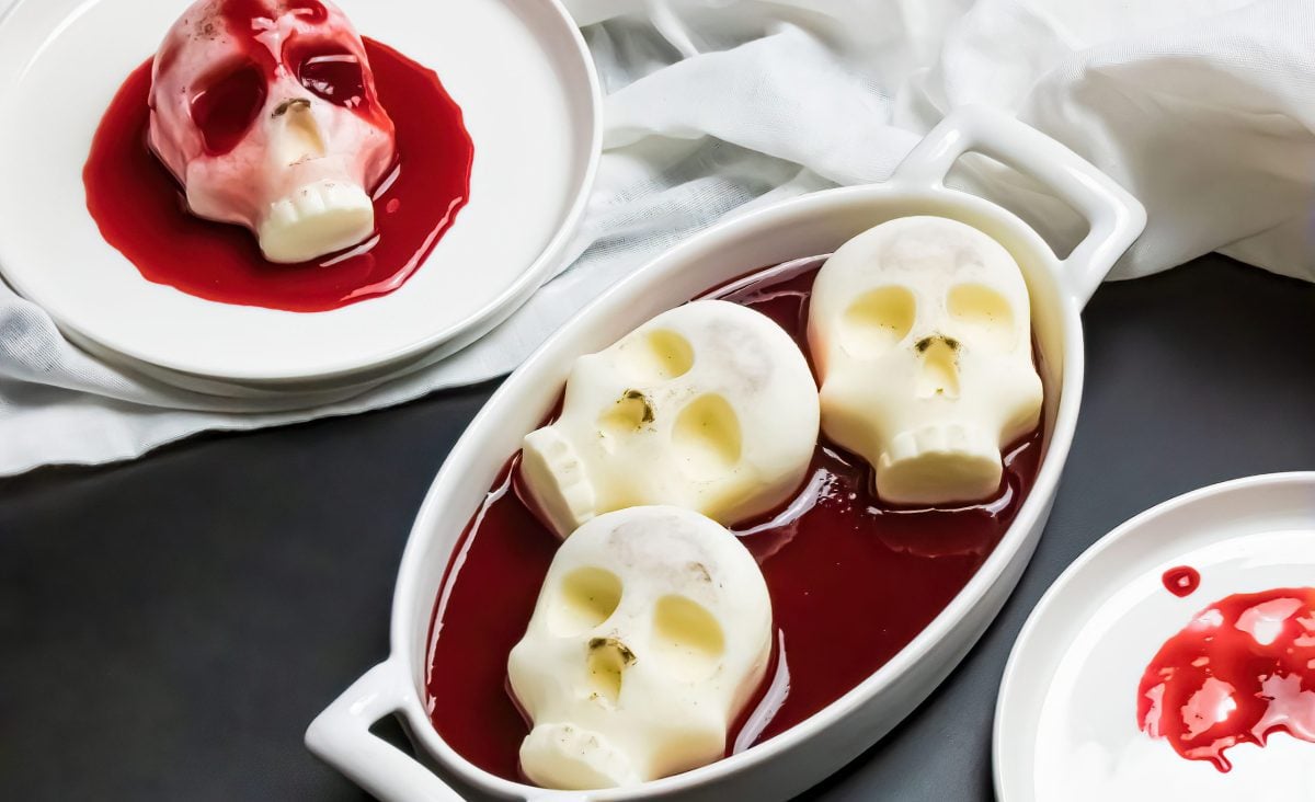 The photo represents the recipe: Vanilla Halloween Panna Cotta with Raspberry Coulis