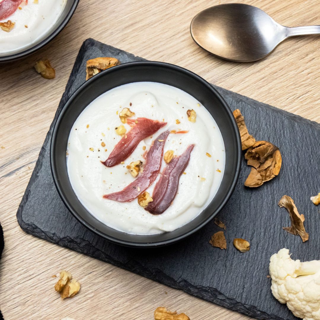 The photo represents the recipe: Creamy cauliflower soup with dried duck breast and coconut cream