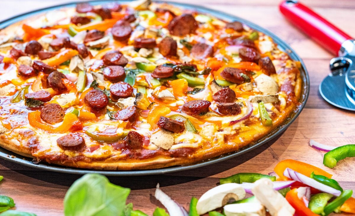 Homemade BBQ sauce pizza with mushrooms and merguez